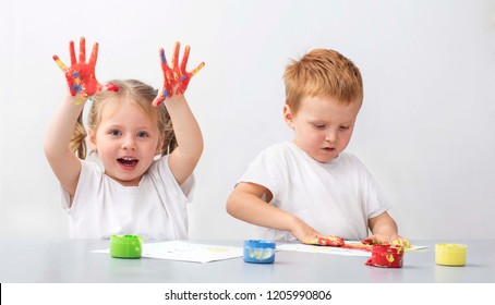 Two Children - A Boy And A Girl - Playing With Finger Paints - Hands In Colours -sensory Therapy At Autism