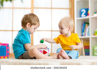 two children boys play together educational toys in playroom