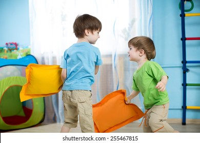 Two Children Boys Playing With Pillows At Home