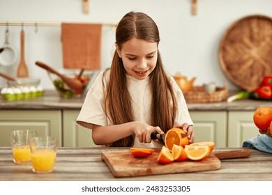 Two children are in the bright kitchen cutting oranges to make juice, symbolizing a happy and healthy family lifestyle centered around homemade goodness - Powered by Shutterstock