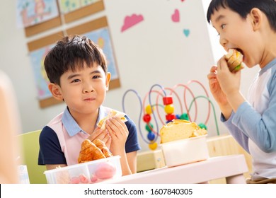 Two Children Eating Delicious Food