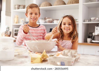 Two children having fun baking in the kitchen - Powered by Shutterstock