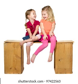 Two Children Laughing Sitting On A Bench. Isolated On A White Background