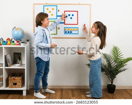 Two children are learning math using colorful magnets on a whiteboard in a bright classroom. The indoor shot highlights the tools and decor used in early childhood education.