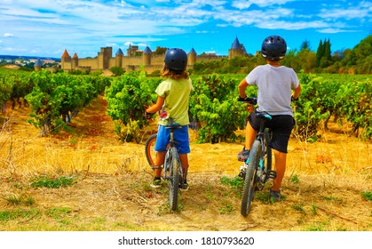 two children looking at beautiful castle of Carcassonne in France