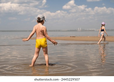 two children running in shallow water, happy childhood, summer swimming, shallow water, boy, girl, child, kids - Powered by Shutterstock