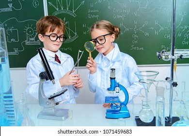 Two children scientists making experiments in the laboratory. Educational concept. Early development of children.