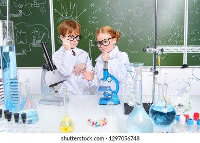 Two children scientists making experiments in the laboratory. Educational concept. Early development of children. - Powered by Shutterstock