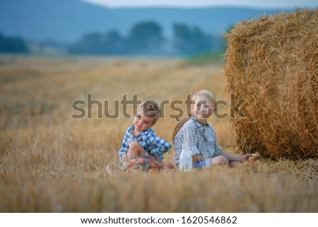 Similar – Vater und Sohn sitzen im Park.