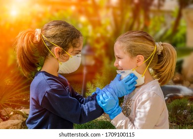 Two Children Smiling That Remove Medical Masks After The Coronavirus Quarantene. Concept Of Freedom And Post Covid 19 Freedom. Return To Life. Life That Begins After Coronavirus. Life Post Quarantine