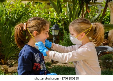 Two Children Smiling That Remove Medical Masks After The Coronavirus Quarantene. Concept Of Freedom And Post Covid 19 Freedom. Return To Life. Life That Begins After Coronavirus. Life Post Quarantine