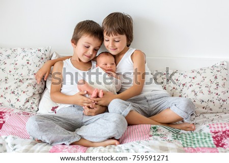 Similar – Children feeding doll with cookie sitting over the bed