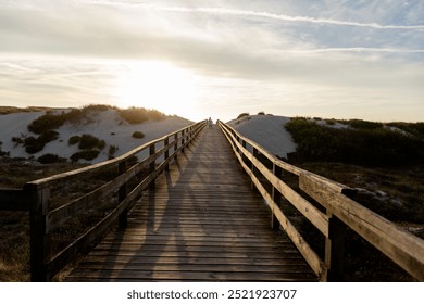 Two children walk along a wooden boardwalk bathed in the warm glow of the sunset. Capturing the essence of freedom, adventure and the beauty of nature. - Powered by Shutterstock