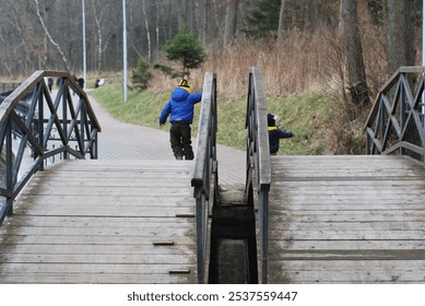 two children, walking, bridge, wooden bridge, outdoors, nature, siblings, friendship, adventure, exploration, childhood, hike, path, forest, kids together, scenic, travel, hand in hand, playful, summe - Powered by Shutterstock