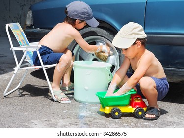 Two Children Washing Car And Toy Car