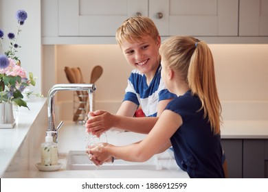 Two Children Washing Hands With Soap At Home To Prevent Spread Of Infection In Health Pandemic - Powered by Shutterstock