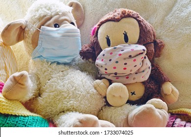 Two Childrens Plush Stuffed Animal Toys Earing A Face Mask During The COVID-19 Pandemic