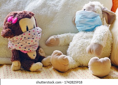 Two Childrens Plush Stuffed Animal Toys Earing A Face Mask During The COVID-19 Pandemic