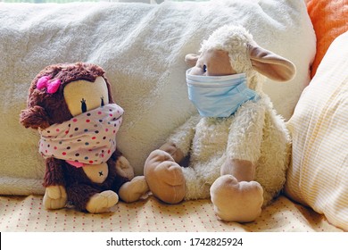 Two Childrens Plush Stuffed Animal Toys Earing A Face Mask During The COVID-19 Pandemic