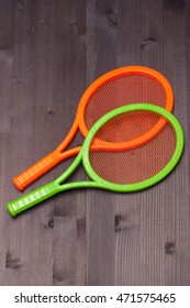 Two Children's Tennis Shoes On A Wooden Board