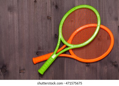 Two Children's Tennis Shoes On A Wooden Board