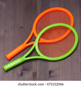 Two Children's Tennis Shoes On A Wooden Board