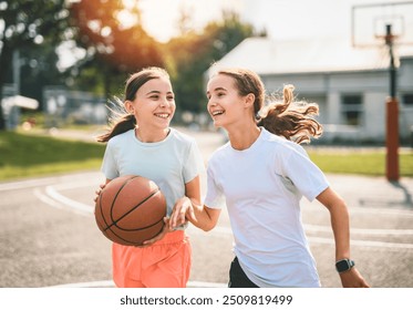 The two childs girls in sportswear playing basketball game - Powered by Shutterstock