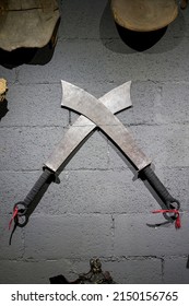 Two Chinese martial arts broadswords hanging on the wall