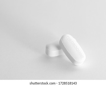 Two Chloroquine Pills For Malaria / COVID-19 Treatment In White Background