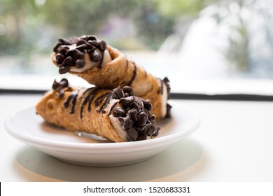 Two Chocolate Chip Cannolis on a Plate