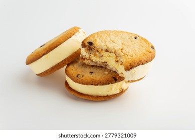 Two Chocolate Chip Cookie Ice Cream Sandwiches On Clean White Background, Creamy Vanilla Filling Slightly Melting, Goldenbrown Cookies With Visible