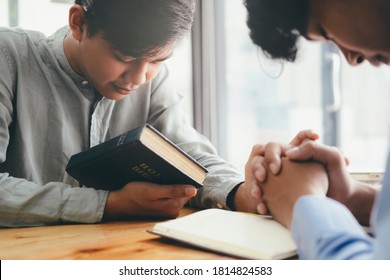 Two Christian People Are Praying Together Over Holy Bible.