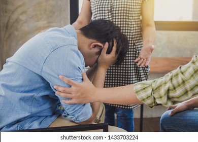 Two Christian People Are Praying For Young Man Friends In Church Prayer Room To Encourage And Support Him In His Problem And Spiritual Growth, Small Prayer Group And Fellowship Concept.