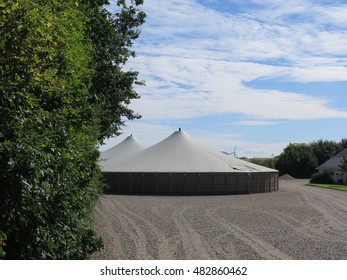 Two Circular Covered Slurry Tanks At Farm In Southern Denmark