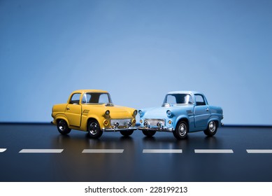 Two Classic Fifties Scale Model Toy Cars From Front View.