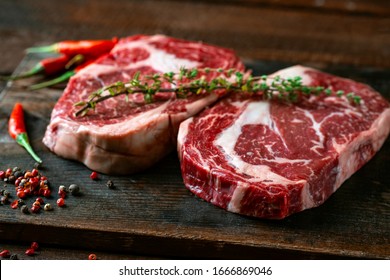 Two classic fresh rib eye steaks on a wooden Board