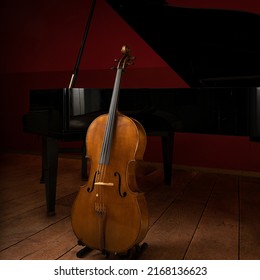 Two Classical Instruments -  The Cello And The Grand Piano - On A Stage Waiting For Their Musicians Before A Recital