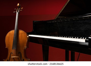 Two Classical Instruments -  The Cello And The Grand Piano - On A Stage Waiting For Their Musicians Before A Recital