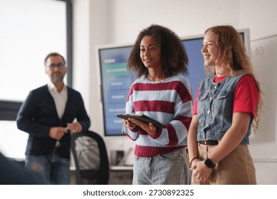 Two classmates presenting group project in front of class.
