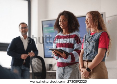 Two classmates presenting group project in front of class.