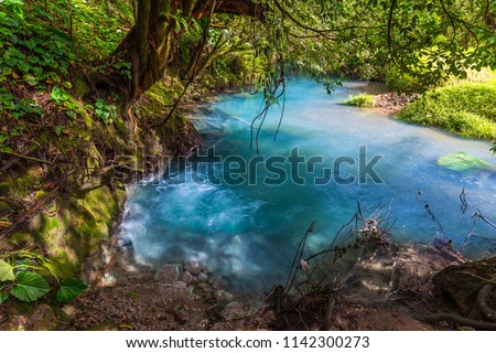 Two clear rivers with different acidity mix and create the river with turquoise water. Rio Celeste, Costa Rica