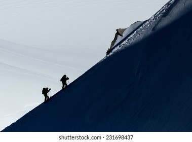 Two Climbers On A Mountain Ridge