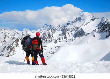 Two Climbers On The Mountain Summit