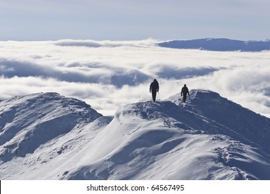 Two Climbers On A Mountain Top In Winter, Piatra Craiului Mountains, Romania