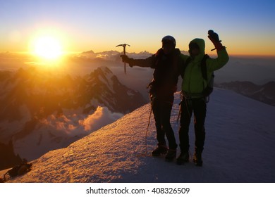 Two Climbers On The Summit Of Mont Blanc At Sunrise