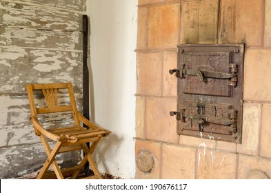 two closed old retro rustic furnace doors with handle and wooden rest chair 
