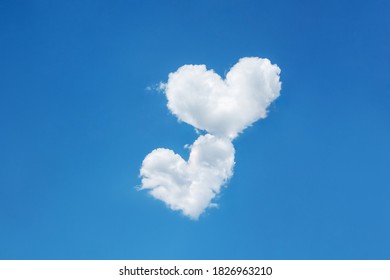 Two clouds in the shape of heart on a blue clear sky. Symbol of love, devotion, feelings, relationship
