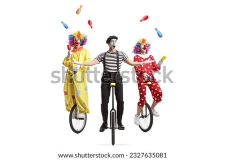 Two clowns and a mime riding unicycles and juggling isolated on white background
