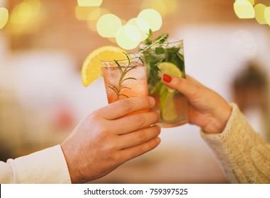 Two cocktail glasses in man and woman hand. Close up - Powered by Shutterstock