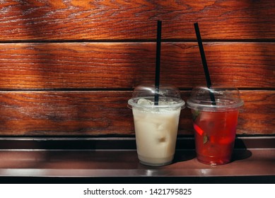 Two Cocktails In Disposable Plastic Cups. Coffee And Lemonade To Go Take Away.